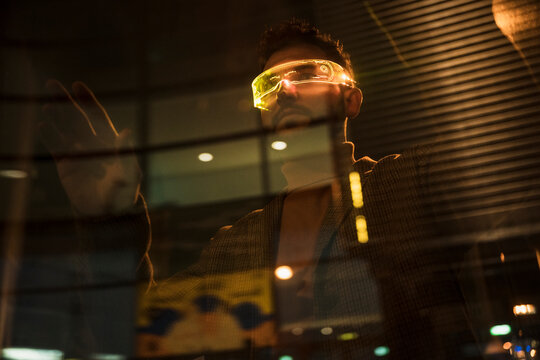 Man wearing smart glasses and gesturing on glass