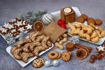 Various Christmas cookies and biscuits on plates.
