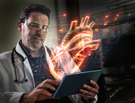 Doctor examining human heart on tablet with help of augmented reality