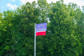 Polish and European Union flags against the background of green trees, Subcarpathian, Poland