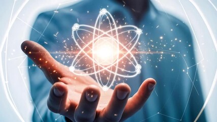 Hand Holding Glowing Quantum Atom Symbol