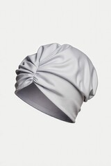 Elegance Unveiled: A minimalist studio shot of a stylish turban, its graceful folds and soft fabric evoking a sense of refined fashion.