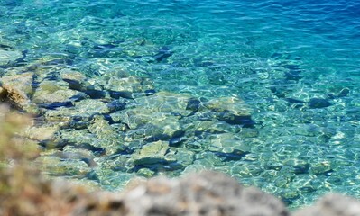 Turquoise clear sea surface in nuances of blue on the beach summer background