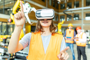 Industrial worker in robotics factory using virtual reality simulator