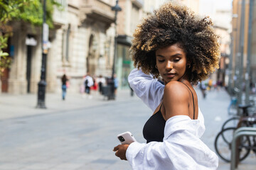 Black woman with afro hair in street