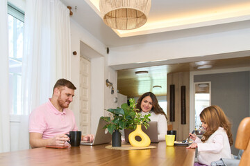 Latin pregnant family working and having breakfast at home