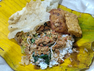Nasi pecel or sego pecel is a typical Javanese Indonesian rice dish served with pecel sauce, which...