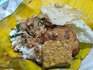 Nasi pecel or sego pecel is a typical Javanese Indonesian rice dish served with pecel sauce, which...