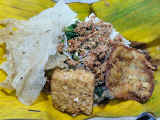 Nasi pecel or sego pecel is a typical Javanese Indonesian rice dish served with pecel sauce, which...