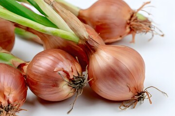 Close-up of shallots with skins and shoots, showing texture and color.