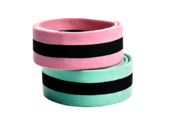 Two colorful fabric resistance bands, one pink and one mint green with black stripes, stacked together isolated on a transparent background