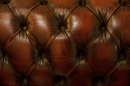fragment of upholstery of a brown leather sofa