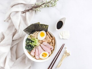 A bowl of Japanese ramen topped with a half-boiled egg, served flat lay style.