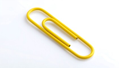 Obraz premium Yellow paperclip on white background