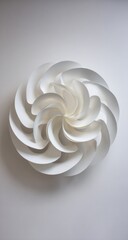 White, abstract sculpture featuring layered, swirling petals or segments arranged in a circular, floral shape on a plain white background, casting a soft shadow