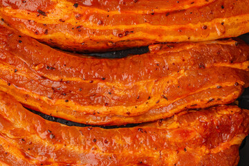 Raw marinated pork ribs with spicy seasoning, close-up texture ideal for barbecue preparation