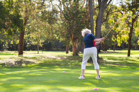 senior golfer teeing off