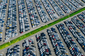 Aerial drone view of Parking lots. New hybrid or electric cars storage area. Many colorful cars...