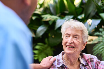 Senior woman enjoys a caring conversation in an outdoor rehabilitation setting
