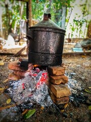 boil water in a large pot with firewood