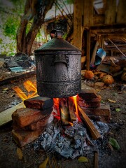 boil water in a large pot with firewood