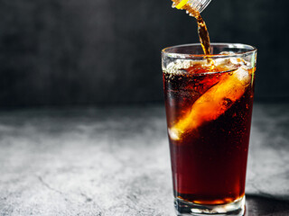 Pouring of Cola and Ice, Cola soft drink with ice cubes, soda fizzy drink in Cold glass