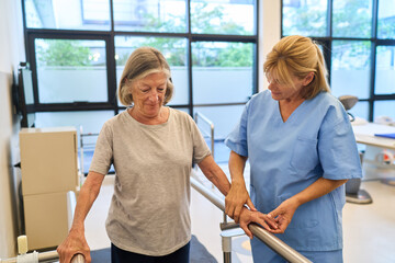 Senior woman receiving guidance from a therapist in a rehabilitation facility
