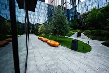 Modern office building courtyard with green areas and seating
