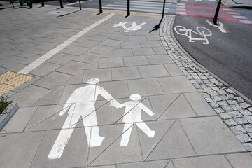 Pedestrian and bicycle path markings on urban pavement in day light
