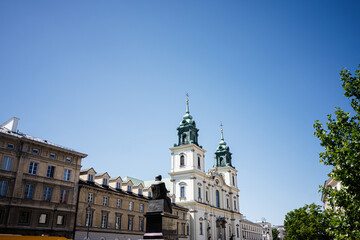 Baroque Church of the Holy Cross with blue sky background located in historic Warsaw city center