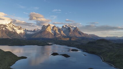 Aerial view of the majestic, snow-capped peaks of Torres del Paine National Park reflected in the tranquil blue waters below, Puerto Natales, Magallanes and Chilean Antarctica, Chile.