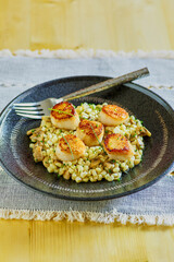 pan seared sea scallops on a bed of sautéed corn, topped with chives