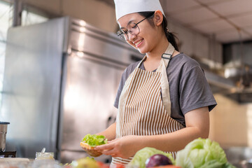 Smiling Young Female Chef Preparing a Sandwich in a Professional Kitchen