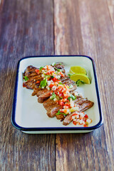 grilled skirt steak topped with fresh pico de gallo salsa, cilantro, and lime juice