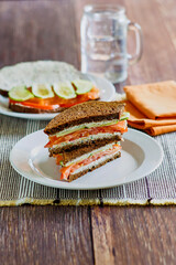 smoked salmon, cucumber, tomato, and cream cheese sandwich