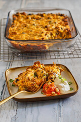 Southwest style breakfast casserole with eggs, sausage, black beans, salsa, and sour cream