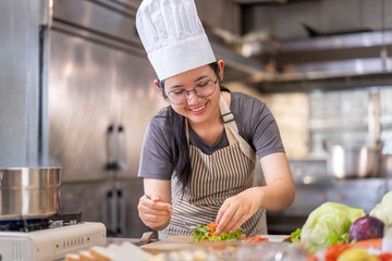 Smiling Young Female Chef Preparing a Sandwich in a Professional Kitchen