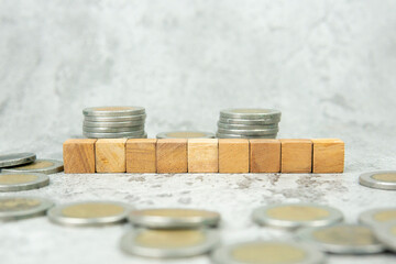Nine blank wooden block cubes and coins, investment concept, income, trends, inflation, business growth, economic growth concept.