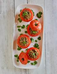 ground beef stuffed tomatoes made with onions and fresh herbs, overhead angle