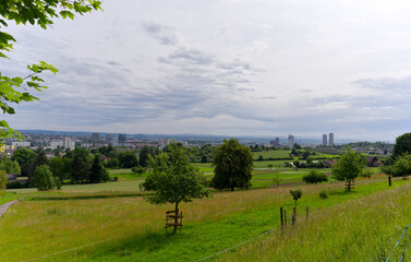 Scenic rural landscape with skyline in the background at Swiss city of Zürich on a spring day....