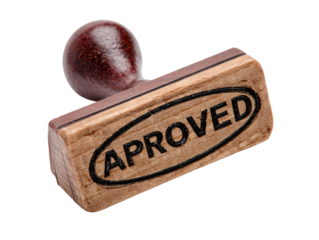 Close-up of a wooden stamp.  The stamp is light brown with dark brown markings. 