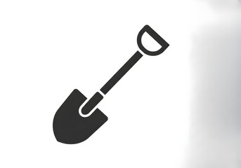 A simple dark gray shovel with a d shaped handle isolated on a plain white background space