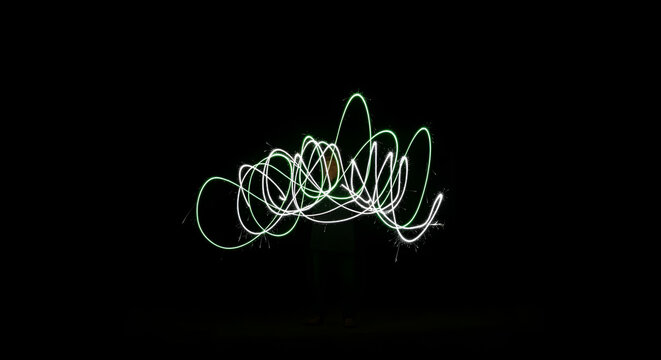 Abstract light painting creates a whimsical and magical effect against a dark background