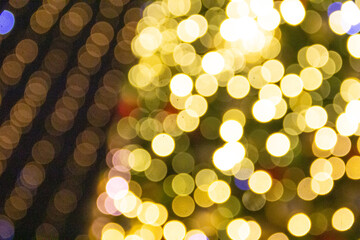 Abstract circular bokeh background of christmas tree in the city