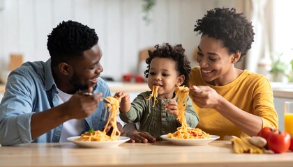 Joyful African American family enjoying a spaghetti meal together at home