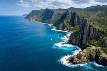 Obraz premium Dramatic cliffs rising from turquoise ocean in tasmania, australia