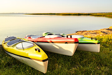 Kayaks on the lake shore, summer vacation on the lake.