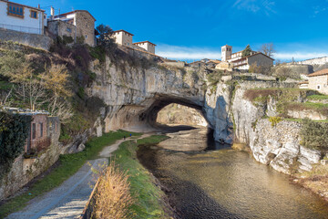 Obraz premium Aerial view of Puentedey, a picturesque village with a natural bridge over the river. Burgos, Spain. High quality photo