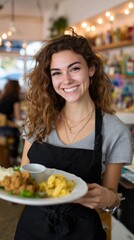 Smiling female waitress serving food in cafe setting
