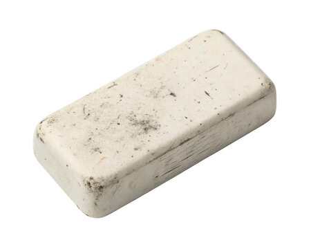 A rectangular white rubber eraser slightly dirty and used sits isolated against a clean transparent